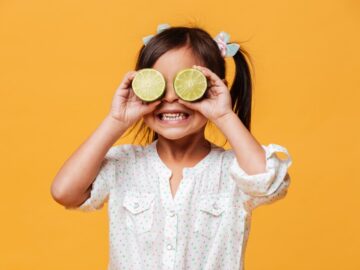little-cute-girl-child-covering-eyes-with-lime_171337-3412.jpg